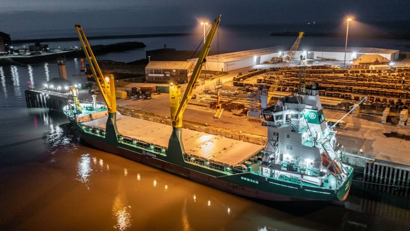 Cargo Ship Docked at a Port at Night Offloading Cargo