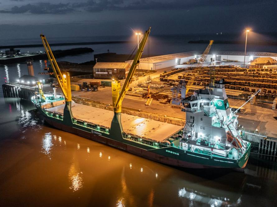 Cargo Ship Docked at a Port at Night Offloading Cargo